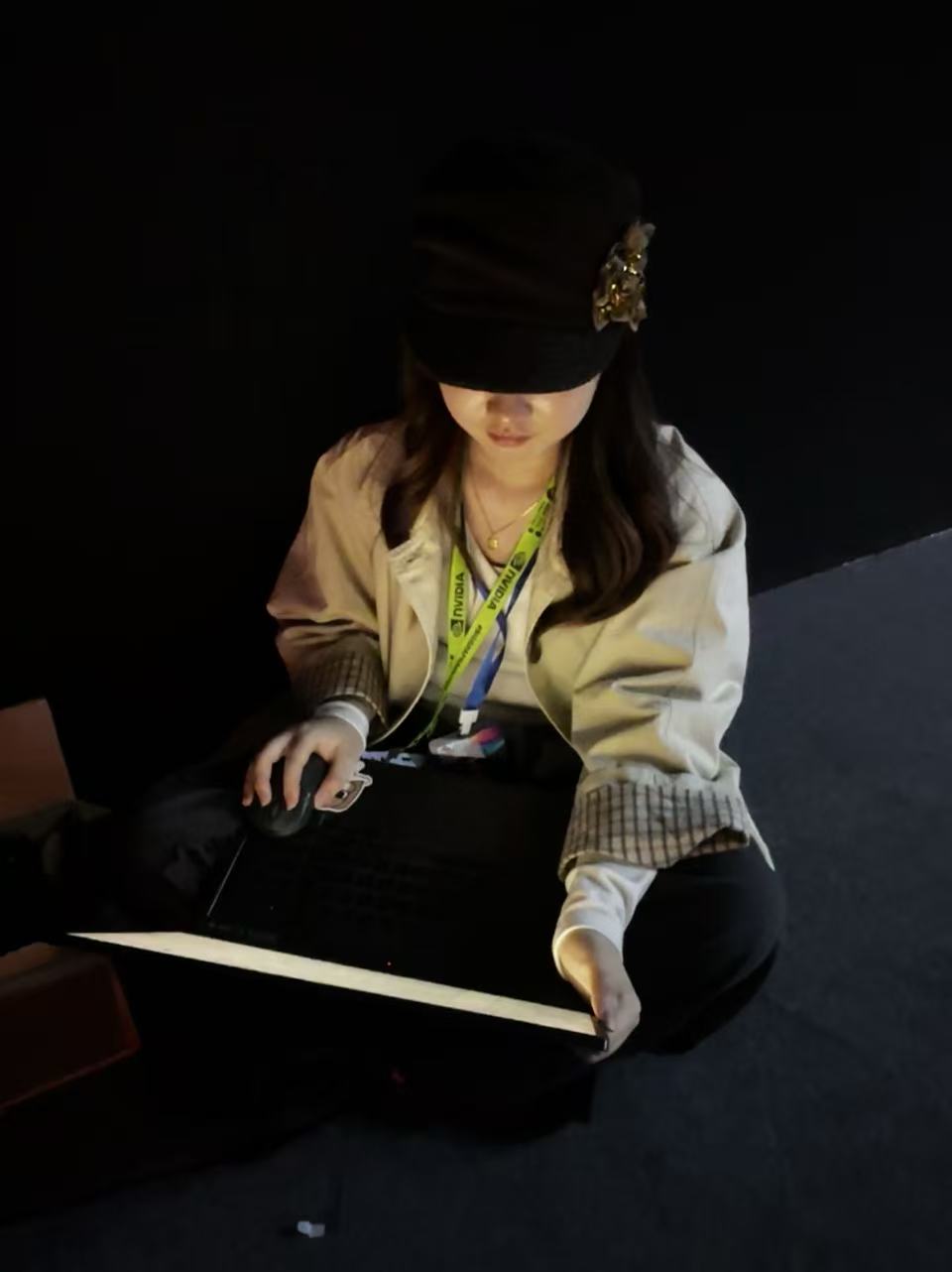 Yiyi Qian interacting with an illuminated installation at the Hong Kong International AI Art Festival