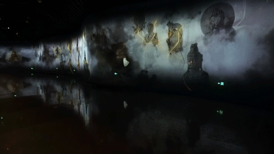 Panoramic exhibition theatre with layered Buddhist figures projected along the wall