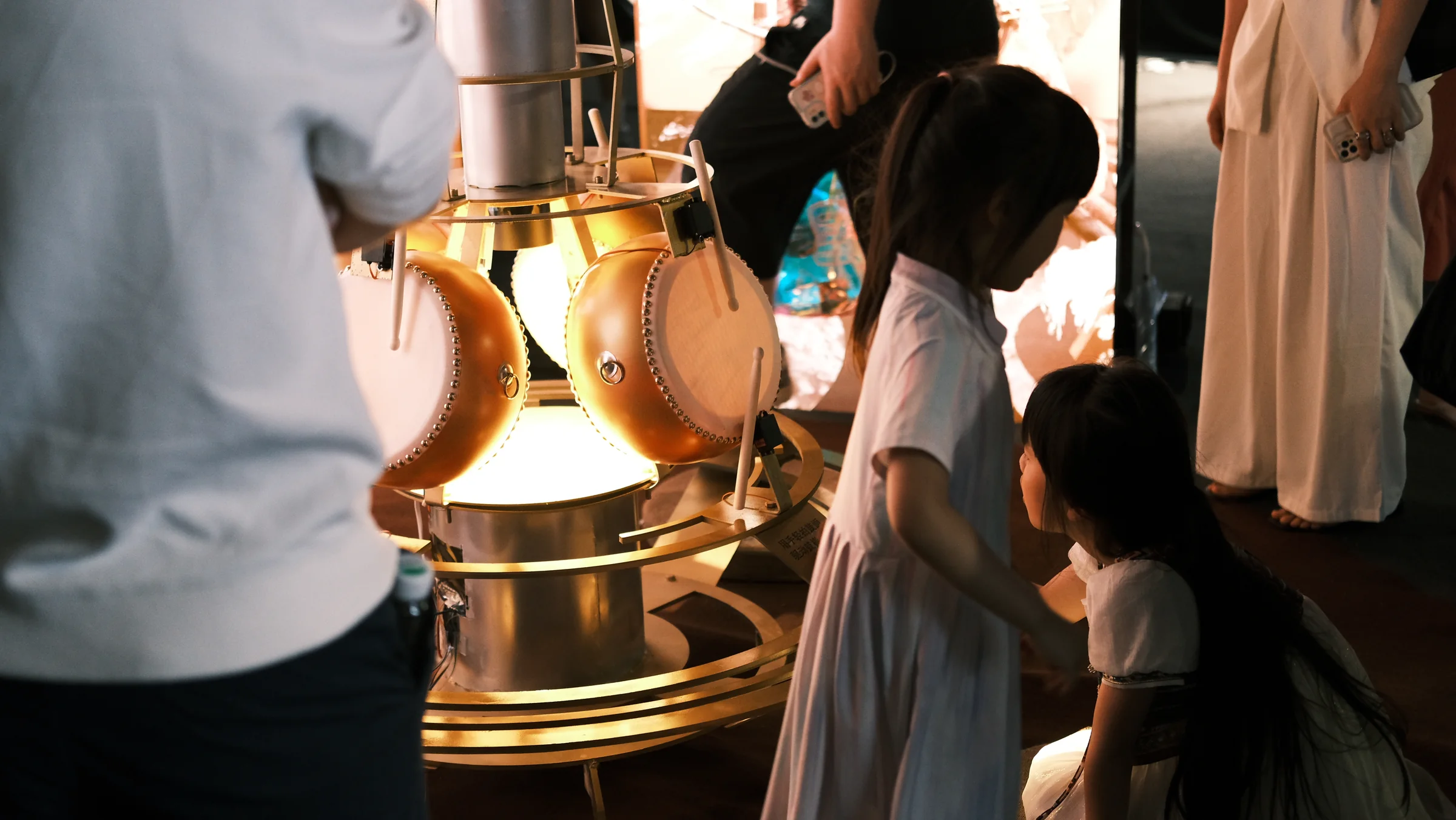 A small group interacting around the central apparatus