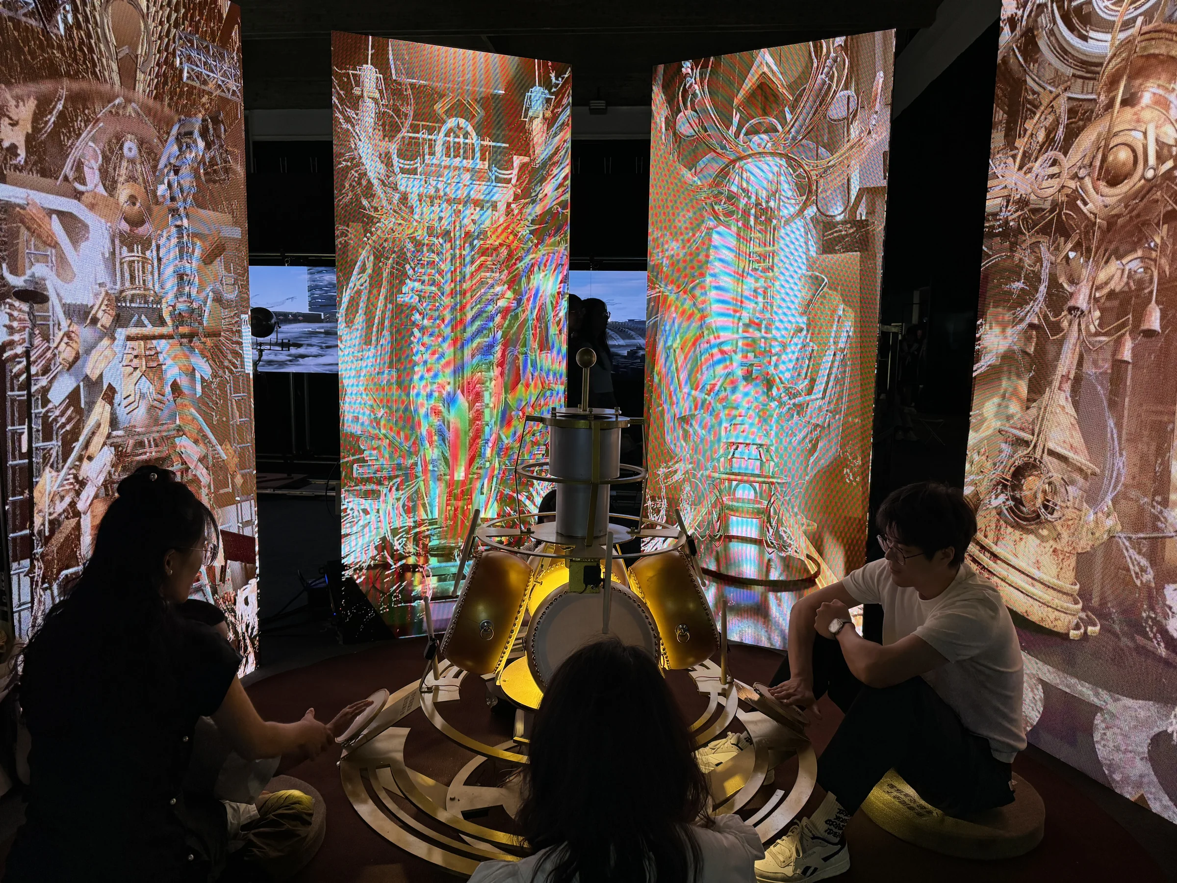 Visitors seated together around the Resonance installation