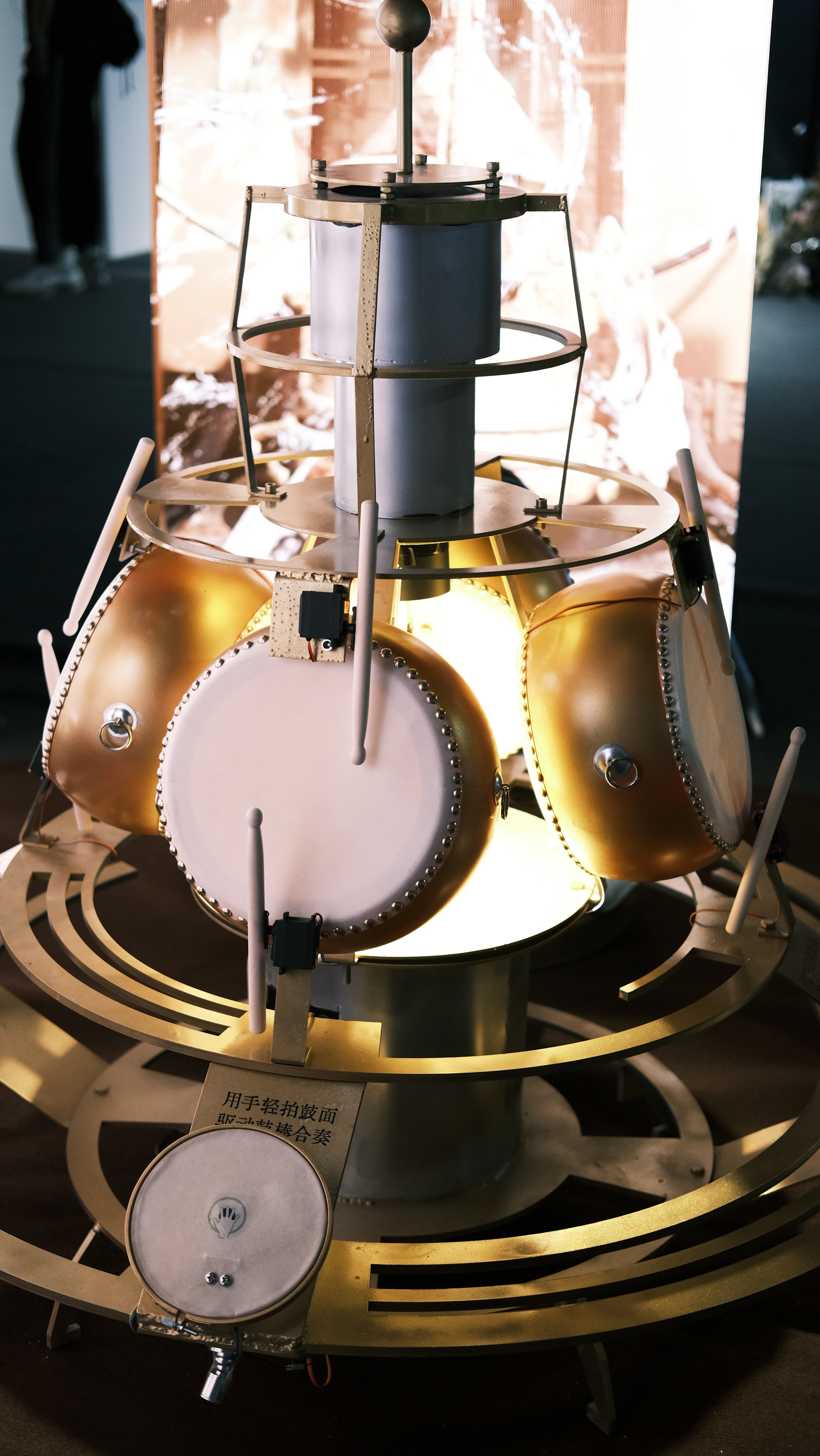 Upright view of the frame drum, robotic mallets, and circular mechanical structure